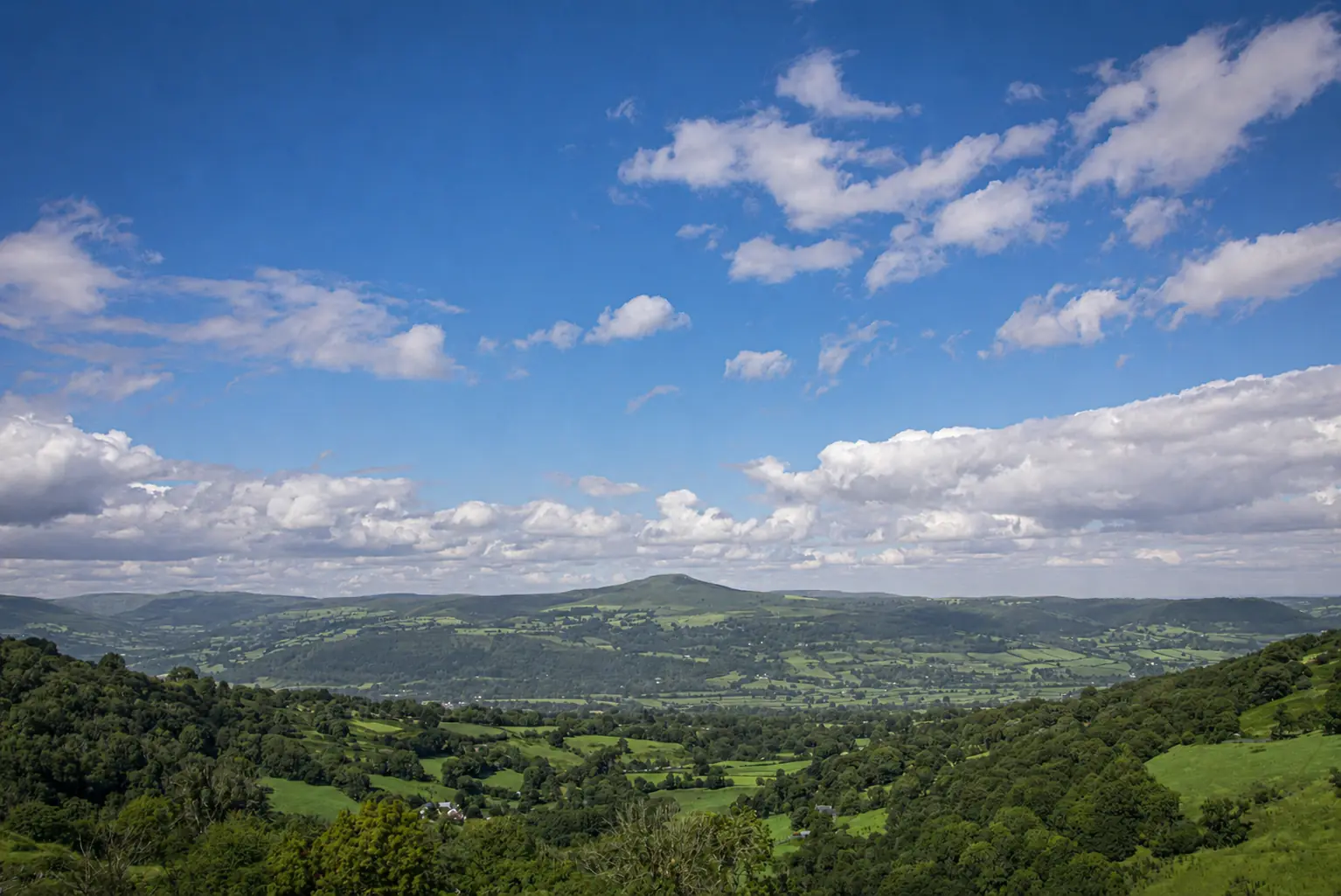 Green hills and open sky above the Vale of Usk near Cwm Sticky Dingle